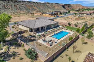 View of subject property featuring a pool and a mountainous background
