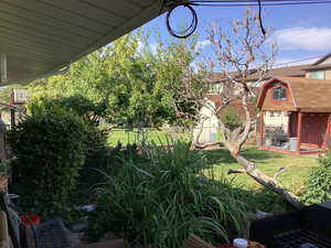 View of yard featuring an outdoor structure and an AC wall unit
