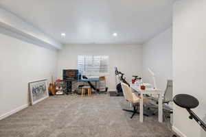 Carpeted office with baseboards and recessed lighting