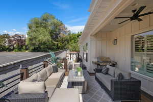 Fenced backyard featuring an outdoor hangout area, a patio, and ceiling fan