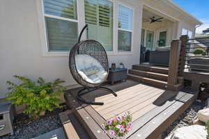 Wooden terrace featuring ceiling fan