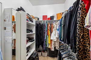 Walk in closet featuring wood finished floors