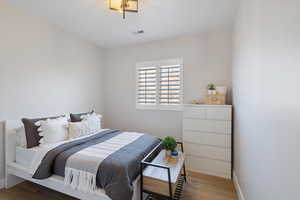 Bedroom featuring baseboards and wood finished floors