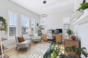 Home office with plenty of natural light and light wood-type flooring