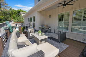 Wooden deck featuring an outdoor living space, ceiling fan, and grilling area