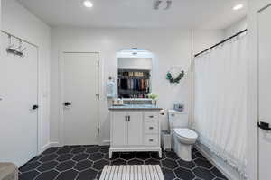 Bathroom with vanity, recessed lighting, and curtained shower