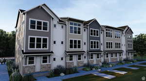 View of front of home with stone siding, a front yard, and stucco siding