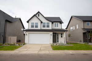 View of front of house with board and batten siding, concrete driveway, a garage, a porch, and roof with shingles