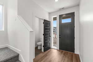 Entryway featuring baseboards and wood finished floors