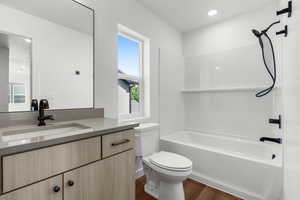 Full bathroom featuring vanity, shower / tub combination, and wood finished floors