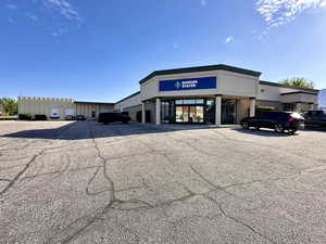View of property featuring uncovered parking