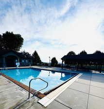 Community pool with a patio