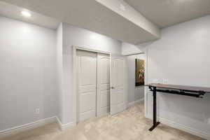 Basement featuring light colored carpet and recessed lighting