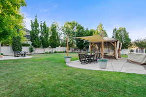 Fenced backyard with a gazebo and a patio