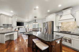 Kitchen with tasteful backsplash, dark wood-style flooring, open floor plan, and recessed lighting