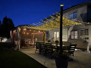 Patio at twilight featuring a patio, outdoor dining space, and a gazebo