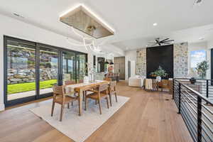 Dining area with a ceiling fan, light wood-type flooring, and recessed lighting
