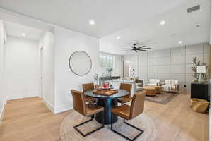 Dining area featuring light wood finished floors, recessed lighting, and a ceiling fan