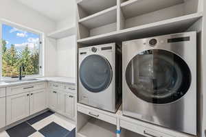Laundry room with washing machine and dryer and light flooring