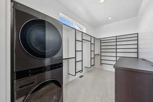 Laundry area with stacked washer / drying machine and recessed lighting
