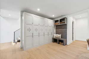 Mudroom featuring light wood finished floors and recessed lighting