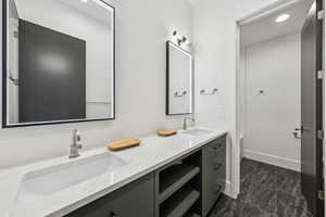 Bathroom featuring double vanity and recessed lighting