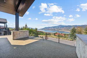 View of patio featuring a water and mountain view