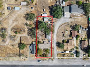 Aerial view of property and surrounding area featuring property parcel outlined