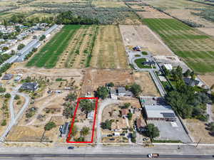 Aerial view of property and surrounding area with property parcel outlined and rural landscape