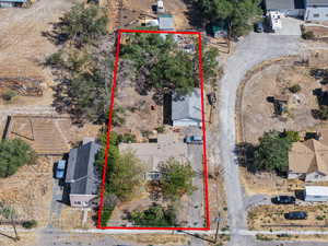 Aerial view of property and surrounding area featuring property parcel outlined