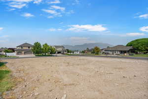 View of yard featuring a mountain view, a residential view, and a garage