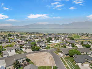 Aerial view of property's location featuring nearby suburban area and a water and mountain view
