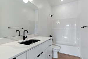 Bathroom featuring vanity, light wood finished floors, and shower / bath combination