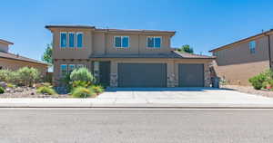 View of front of house featuring driveway, stone siding, an attached garage, stucco siding, and a tiled roof