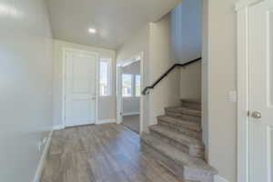 Entryway featuring wood finished floors and stairs