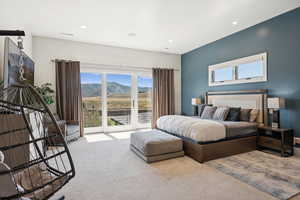 Bedroom featuring multiple windows, access to outside, carpet floors, a mountain view, and recessed lighting