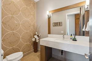 Bathroom with toilet and an accent wall
