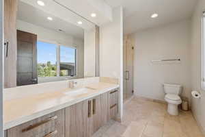 Bathroom with vanity, recessed lighting, a shower stall, and tile patterned flooring