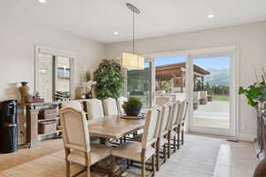 Dining room with light tile patterned floors, a mountain view, and recessed lighting