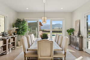 Dining space with a mountain view, light tile patterned flooring, and recessed lighting