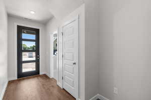 Foyer entrance featuring dark wood-style flooring and a textured ceiling