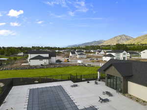 View of swimming pool featuring a fenced backyard, a residential view, a mountain view, and a patio area