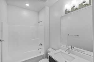 Bathroom featuring vanity and washtub / shower combination