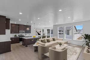 Living room featuring light wood-type flooring and recessed lighting