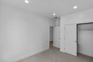 Bedroom 3 with carpet, recessed lighting, and a closet