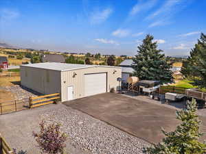 Detached garage with gravel driveway