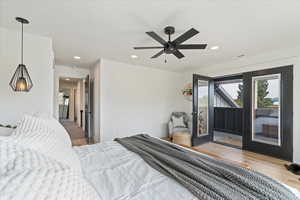 Bedroom with access to exterior, wood finished floors, recessed lighting, and a ceiling fan