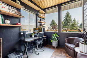 Office area featuring wood finished floors and wood ceiling
