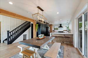 Dining area with stairs, recessed lighting, and light wood finished floors