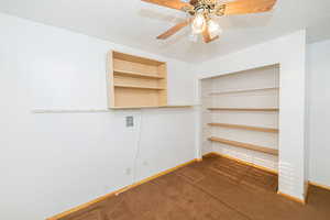Interior space with a textured ceiling, carpet, and a ceiling fan